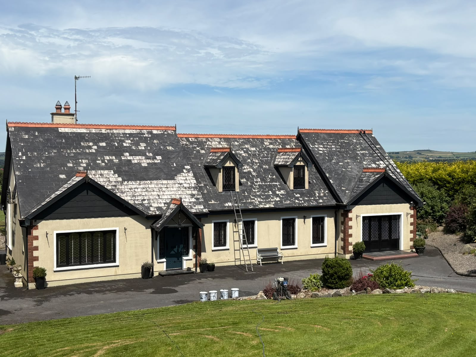 Roof before painting in Kilkenny — mossy, weathered tiles